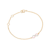 Tiny Jewels gold bracelet with a pink and silver infinity charm on a white background