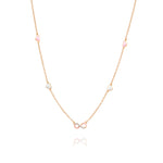 Tiny Jewels delicate necklace with pink and white beads on a gold chain against a white background