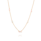 Tiny Jewels delicate necklace with pink and white beads on a gold chain against a white background