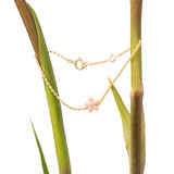 Tiny Jewels gold necklace with a pink flower pendant on a plant stem