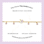 Tiny Jewels gold bracelet with charms on a white card with promotional text on a purple background