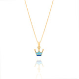 Tiny Jewels gold crown pendant with blue and gold accents on a white background