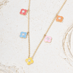 Tiny Jewels necklace with colorful flower pendants on a light background