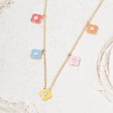 Tiny Jewels necklace with colorful flower pendants on a light background