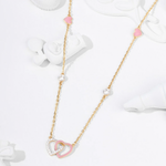 Tiny Jewels necklace with pink heart-shaped pendants on a white background