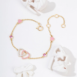 Tiny Jewels gold bracelet with heart-shaped pink beads on a white background