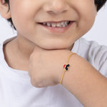 Tiny Jewels child wearing a gold bracelet with a small heart charm on a white background