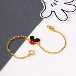 Tiny Jewels gold bracelet with a Mickey Mouse head charm on a gray and white background