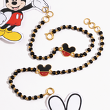 Tiny Jewels black beaded lanyard with gold accents and Mickey Mouse head charms on a white background.