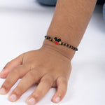 Tiny Jewels child's wrist wearing a bracelet with a Mickey Mouse design on a white background