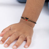 Tiny Jewels child's wrist wearing a bracelet with a Mickey Mouse design on a white background