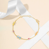 Tiny Jewels gold bracelet with colorful beads on a light background