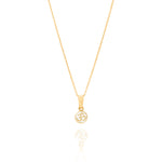 Tiny Jewels gold pendant with Om symbol on a white background