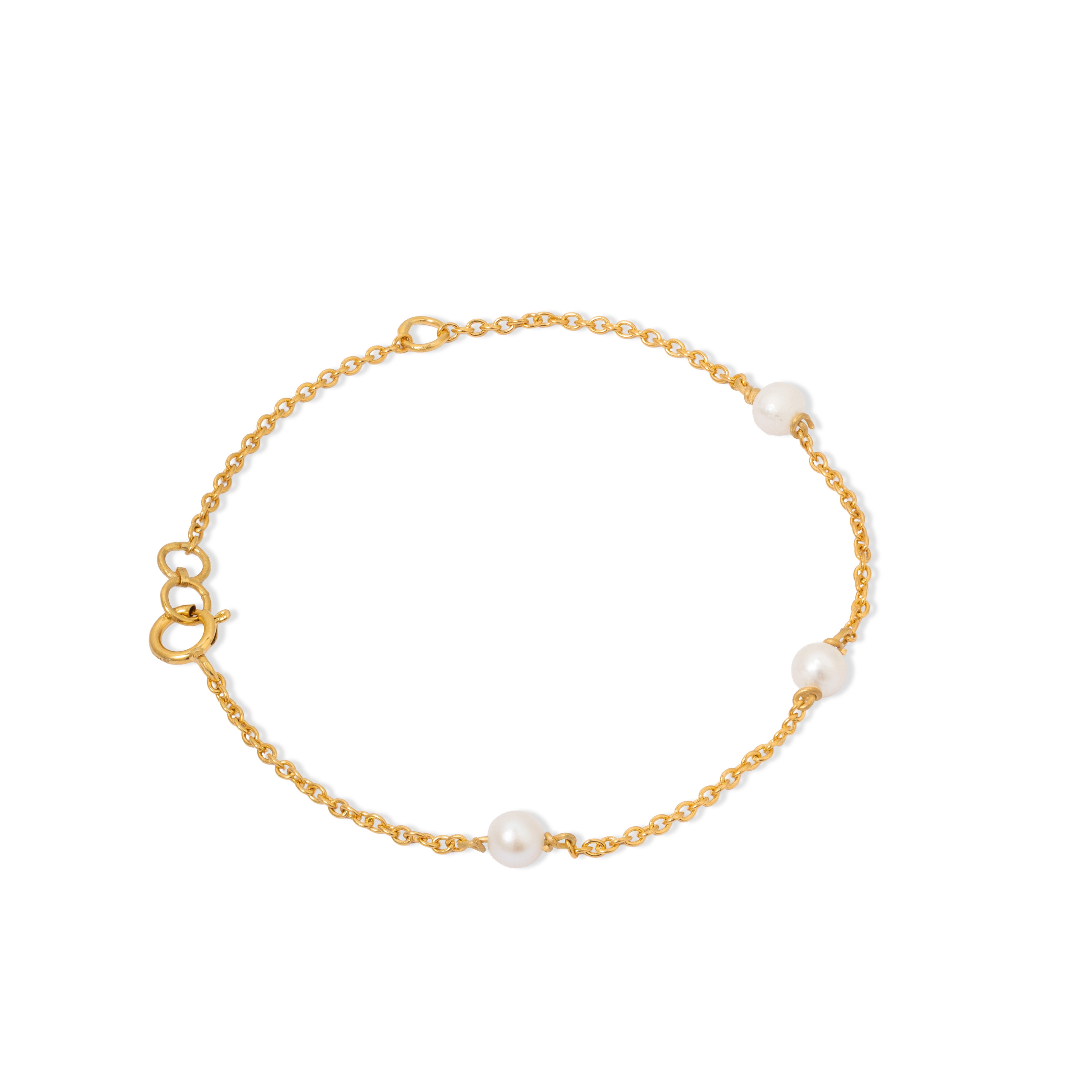 Tiny Jewels gold bracelet with pearls on a white background