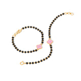 Tiny Jewels black beaded necklace with pink accents and gold clasps on a white background