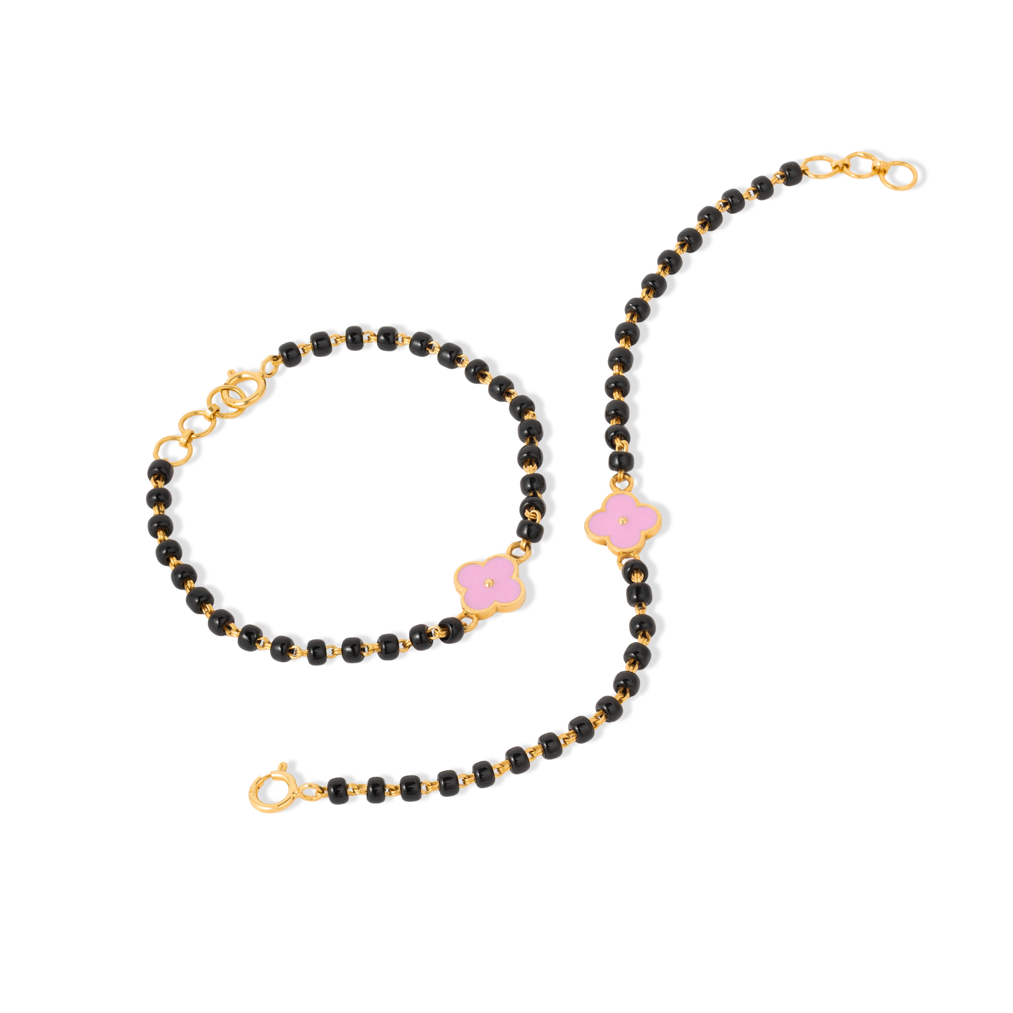 Tiny Jewels black beaded necklace with pink accents and gold clasps on a white background