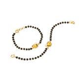 Tiny Jewels black beaded necklace with gold bee charms on a white background