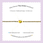Tiny Jewels bracelet with a bee charm on a white background with promotional text about Tiny Jewels Nazariyas.