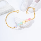 Tiny Jewels gold bracelet with colorful geometric beads on a white surface