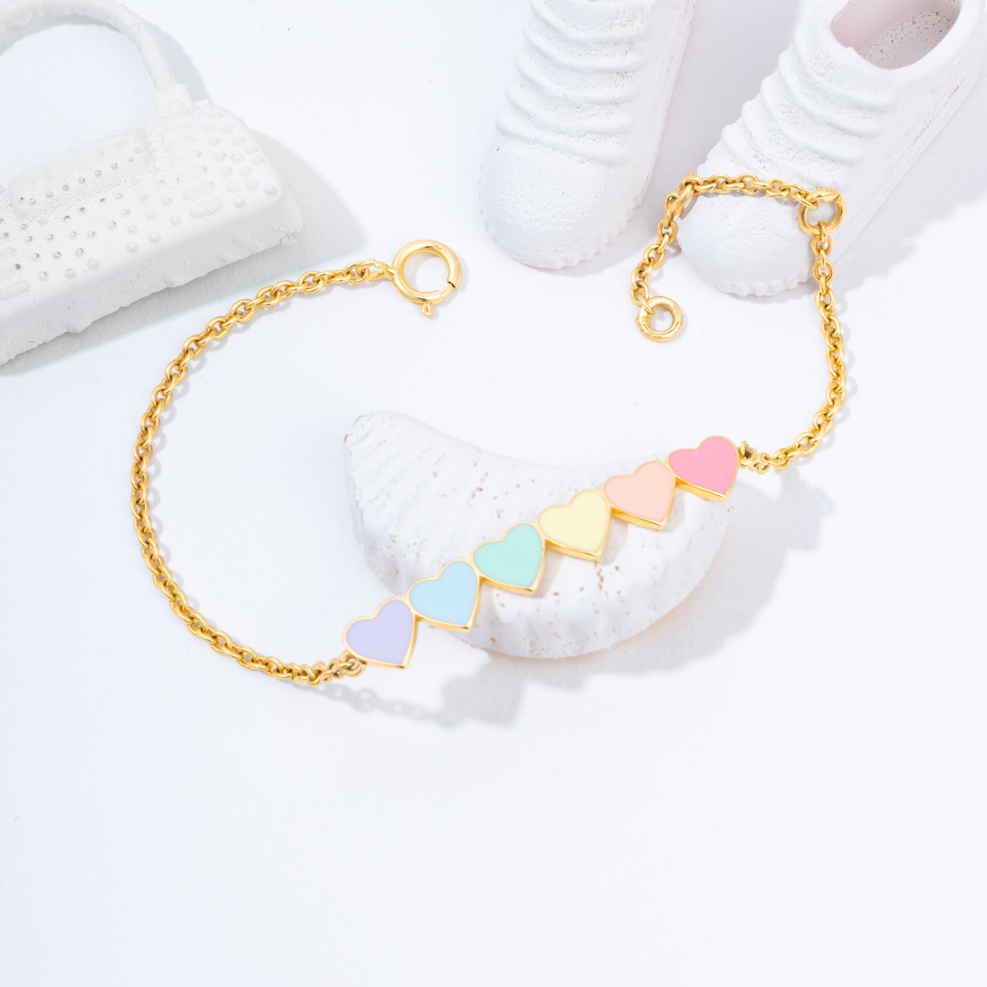 Tiny Jewels gold bracelet with colorful geometric beads on a white surface