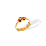 Tiny Jewels gold ring with a red and black gemstone on a white background