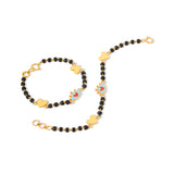 Tiny Jewels bracelet with black beads and gold heart-shaped charms on a white background
