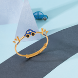 Tiny Jewels gold bracelet with car charm on a blue and gray background