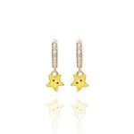 Tiny Jewels star-shaped earrings with gold and yellow colors on a white background