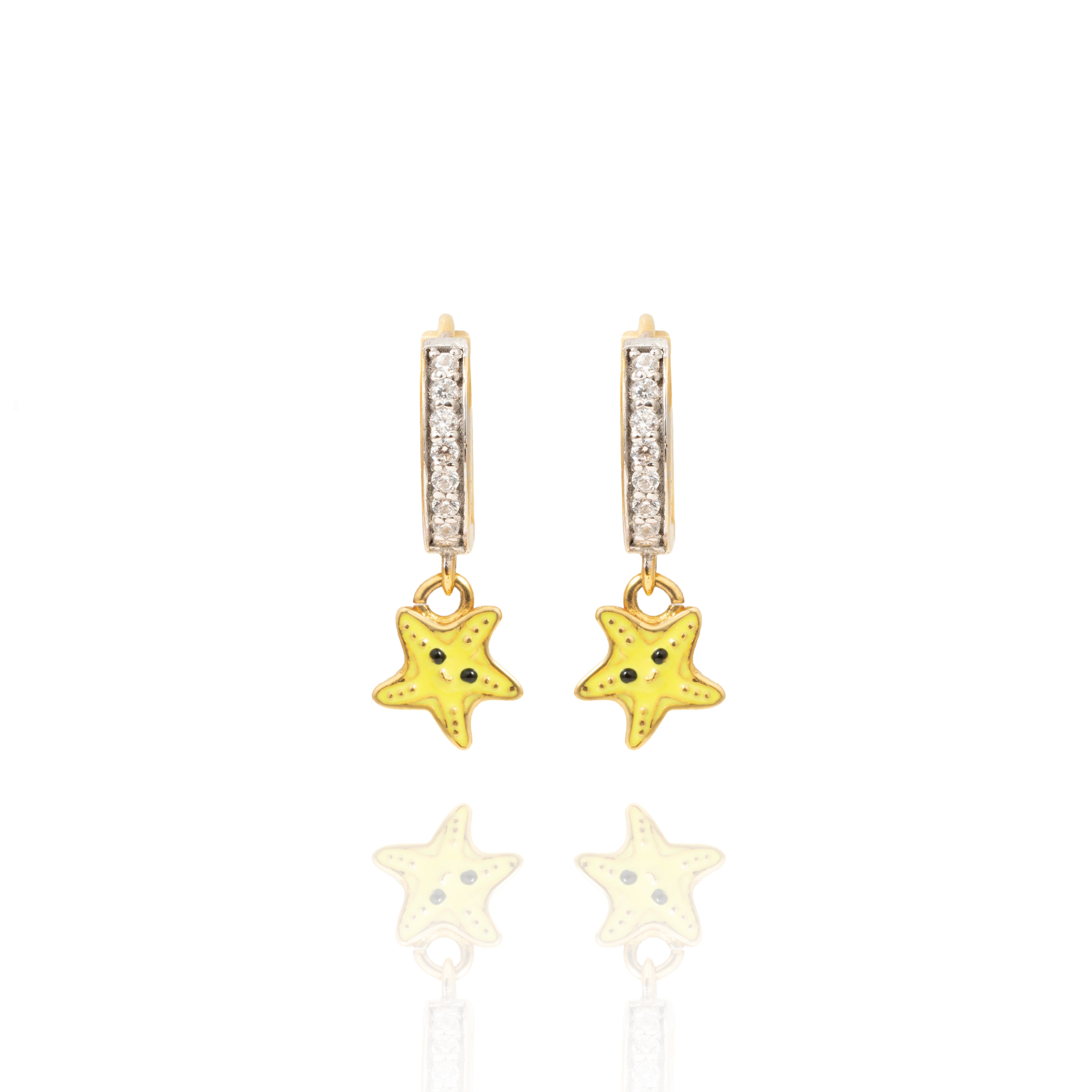 Tiny Jewels star-shaped earrings with gold and yellow colors on a white background