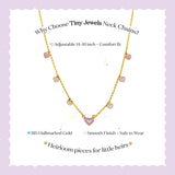 Tiny Jewels gold necklace with heart-shaped charms on a light purple background, featuring text about the product.