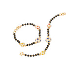 Tiny Jewels necklace with black beads and gold clasp on a white background