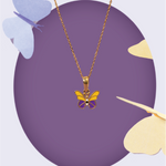 Tiny Jewels Butterfly-shaped pendant on a gold chain against a purple background with butterfly decorations.